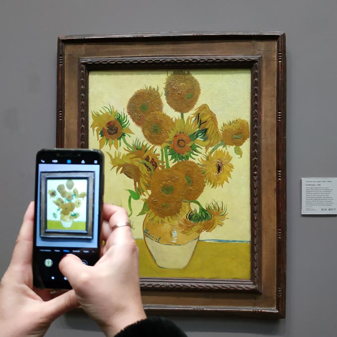 While snapping a shot with a smartphone of Van Gogh's Sunflowers.