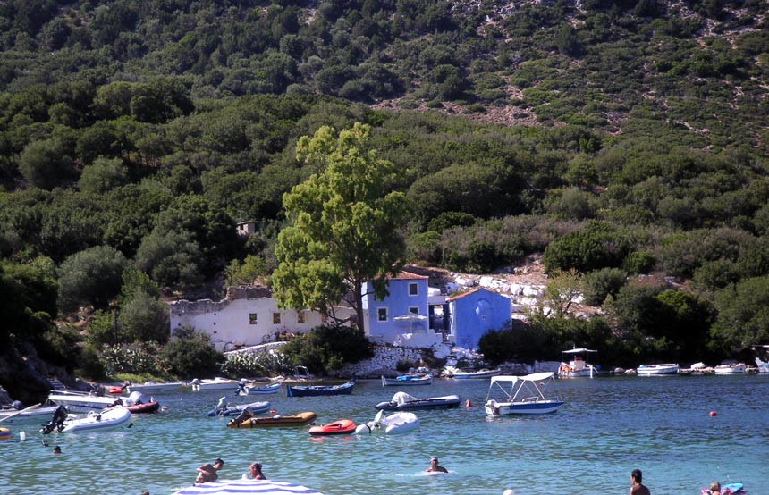 Partial view of the cove of Assos with lush greenery in the background and blue green exotic waters. Image by Velvet Karatzas.