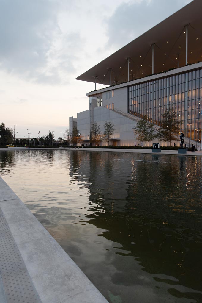 View of the canal and the Stavros Niarchos Foundation Culture Center after sunset.
