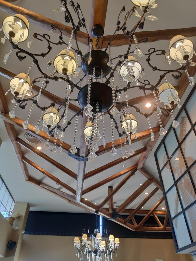 View of a ceiling with two chandeliers.