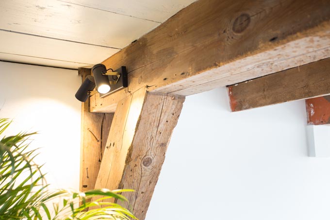 A pair of spotlights on a timber truss. Image by Cuckooland.