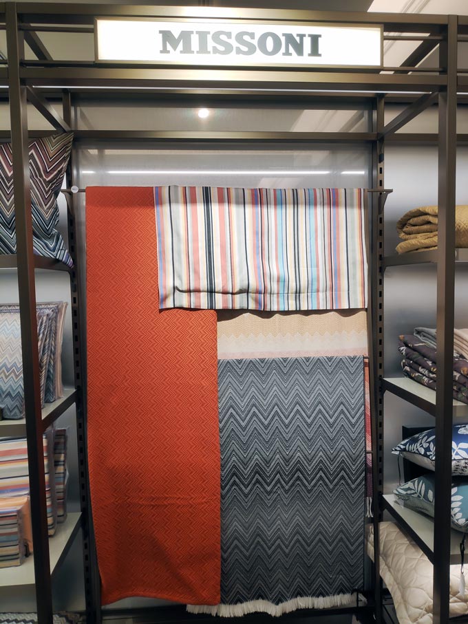 Various throws from Missoni on display in a retail store.