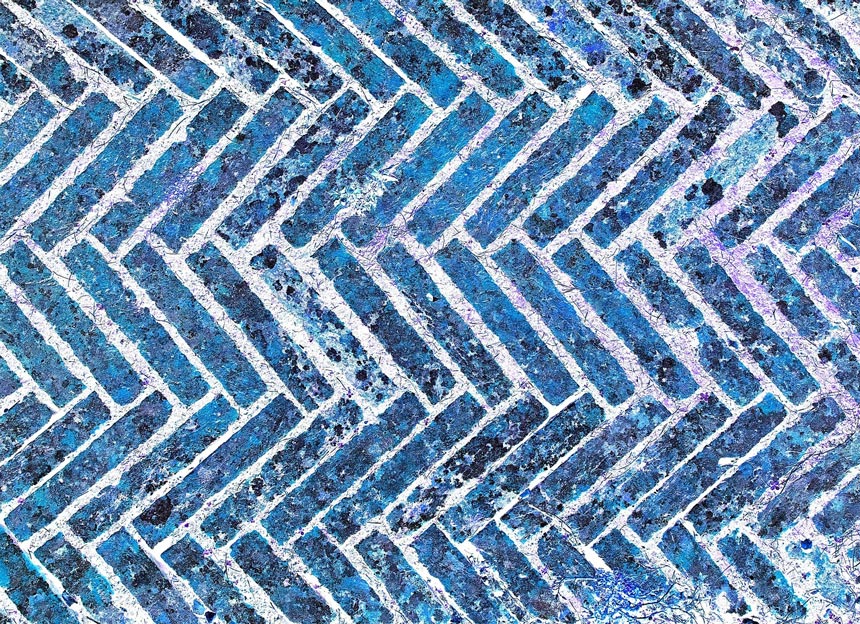 Detail of blue bricks forming a herringbone pattern