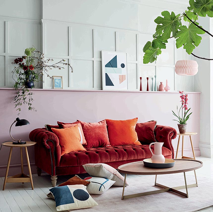 I love this deep rusty red velvet sofa that feels like a more modern take on a very classic sofa type. Image by DFS Furniture.