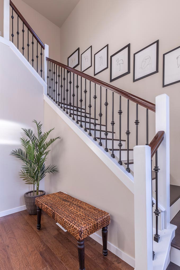 An art gallery wall along a stairway with a cohesive line art theme.