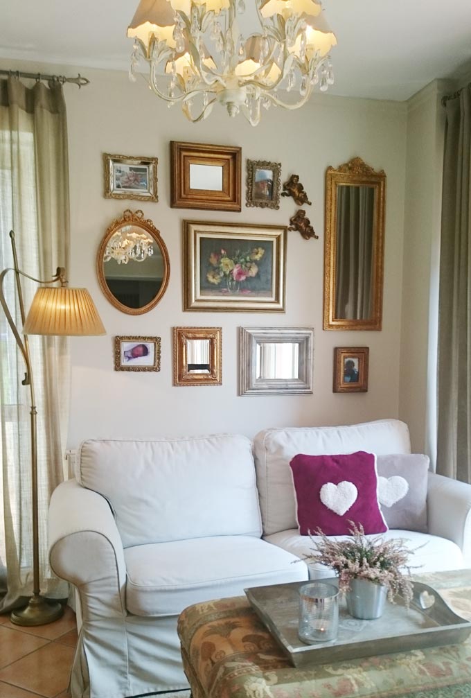 Elisabeth's vignette featuring a white sofa with a floor lamp next to it and an accent gallery wall.