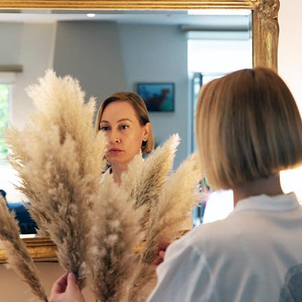 Velvet arranging pampas grass in a vase.