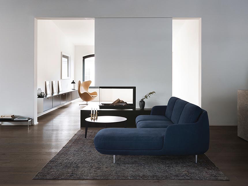 I love this Fritz Hansen Lune three seater sofa with a chaise longue that sits on top of the perfect sized contemporary area rug in this contemporary minimal space. Image by Nest.co.uk.
