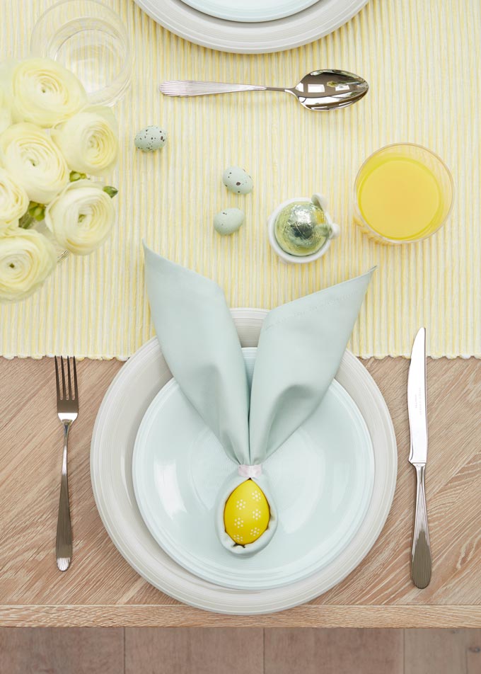 A yellow runner and a yellow egg wrapped in a towel like a bunny face, surely makes a great Easter decorating idea. Image via John Lewis.