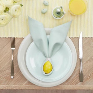 A yellow runner and a yellow egg wrapped in a towel like a bunny face, surely makes a great Easter decorating idea. Image via John Lewis.