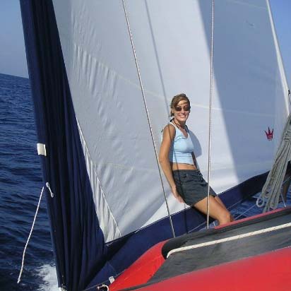 Velvet leaning against a sail while on a sailing trip