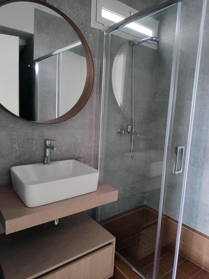 A contemporary bathroom with terrazzo tiling on the walls from a client project of mine.