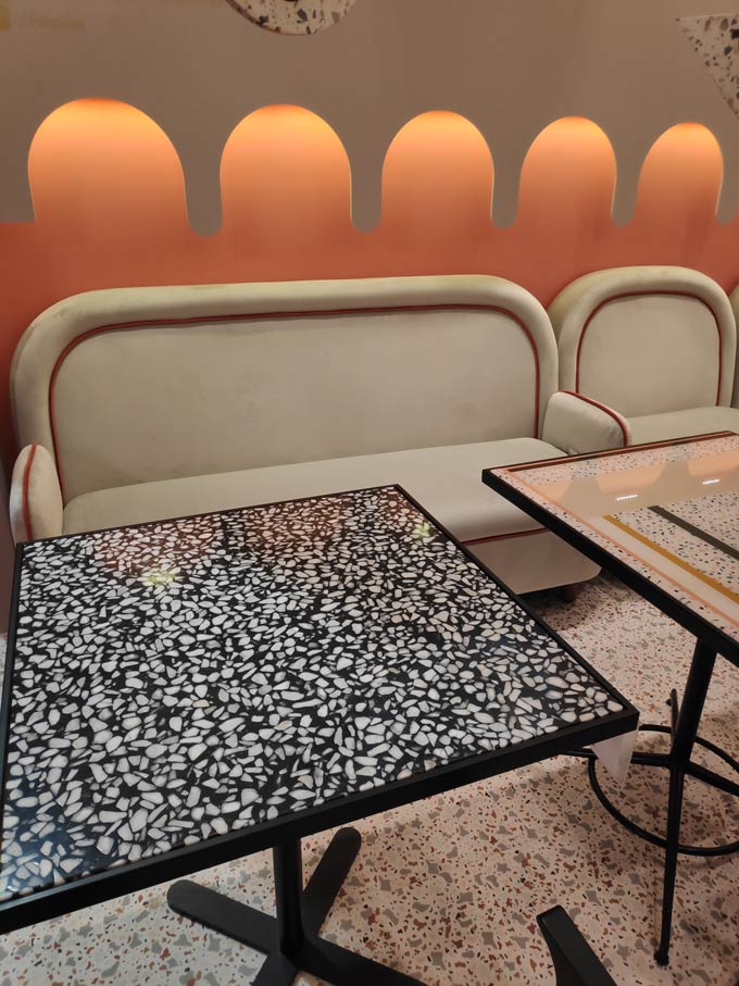 A table with a black and white terrazzo on top of a terrazzo floor as seen at the Salone del Mobile 2019 in Milan.
