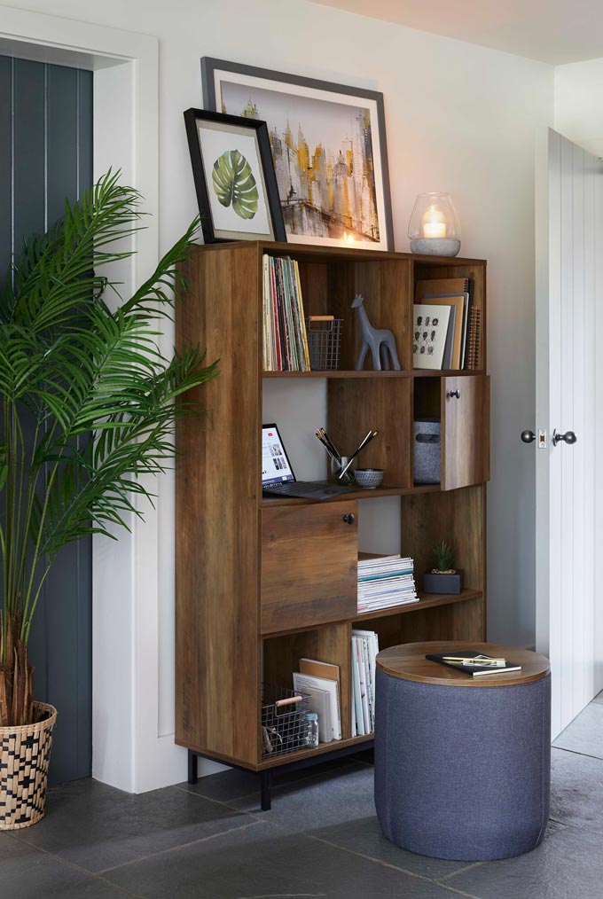 A wooden bookcase unit styled beautifully. Image by Dunelm.