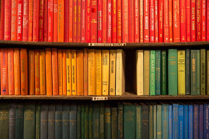 Books placed in bookshelves based on the color of their spine.