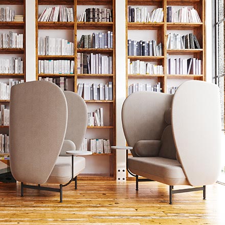 A large home library room with two Fritz Hansen Plenum armchairs that make a huge statement yet provide an incredible sense of discreteness. Image by Nest.