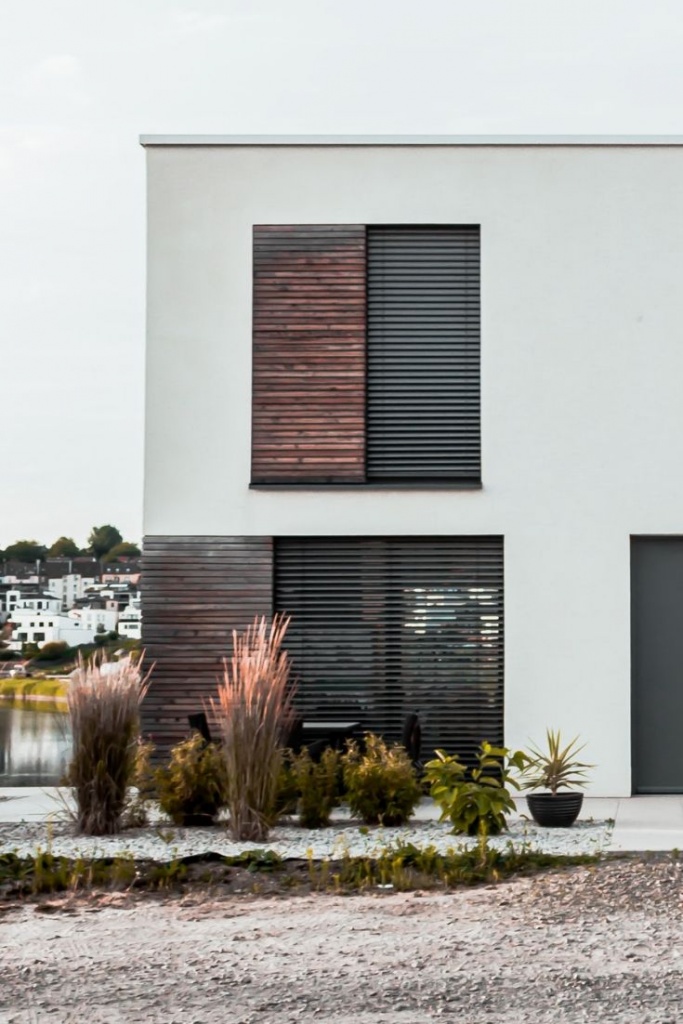The external facade of a contemporary minimal styled building with Venetian blinds.