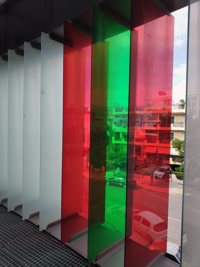 Colored glass panels used on the facade of a building. Image by Velvet.