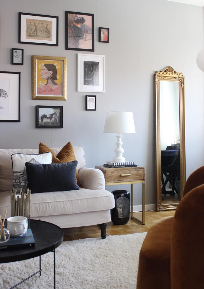 One of the six interior decorating fail proof tips calls for adding a mirror. A stylish living room with an art gallery wall and a mirror. Image by Cult Furniture.