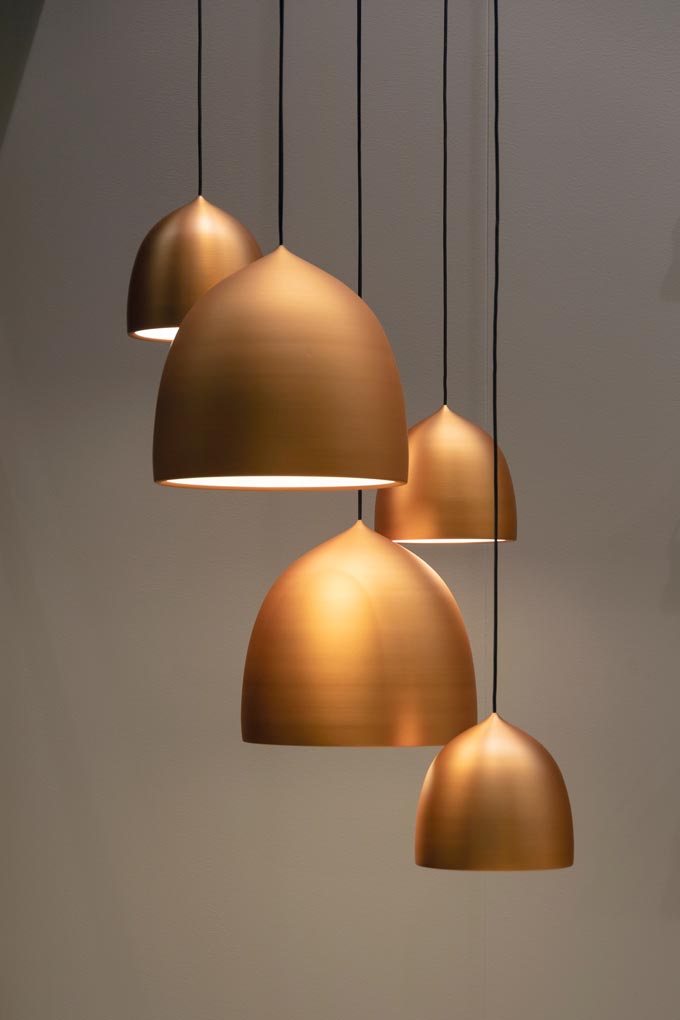 Five rose gold pendant lights.