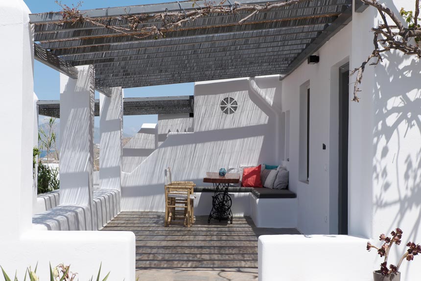 A rather typical cycladic minimal outdoor setting for chilling and dining in a housing complex at Mykonos. Image by Antonis Drakakis.