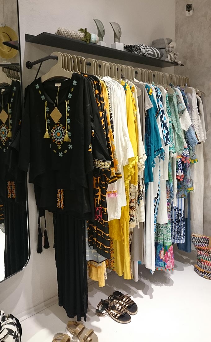 Boho inspired outfits hanging at a Greek island retail store. Image by Velvet.