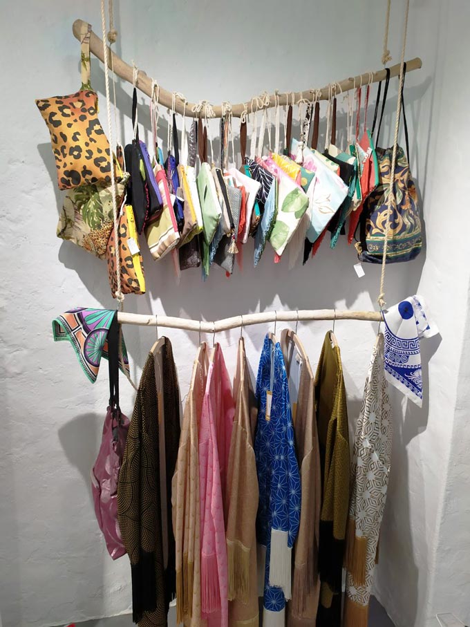 Accessories and boho inspired tunics on display at a Greek island retail store.