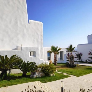 A housing complex of low rise white washed buildings in a typical Cycladic architecture in Paros.