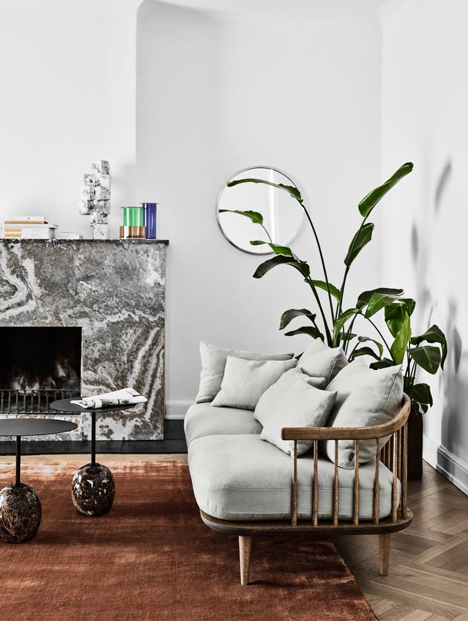 A sofa with the Lato side tables that are crafted from marble and steel, inspired by a lollipop and a veined marble fireplace make up this contemporary setting. Image by Nest.