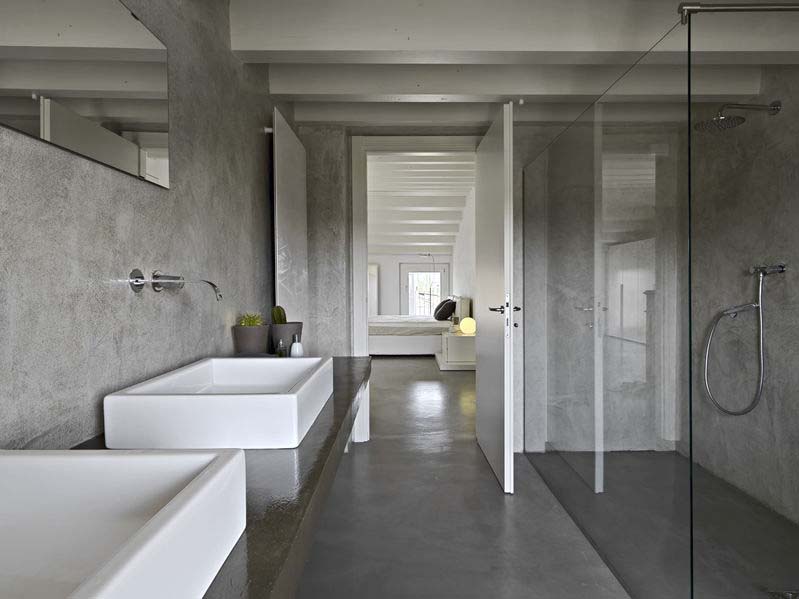 modern batroom with glass shower cubicle. microcement has been applied on the bathroom counter and walls