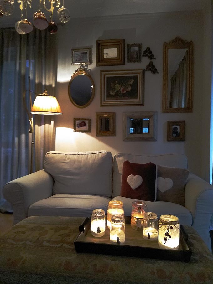 This is one of Elisabeth's vignettes.A cozy vignette with a two seater sofa, a coffee table, a gallery wall as a backdrop and plenty of candles to add that hygge vibe. 