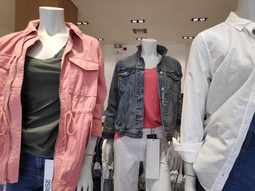 Mannequins dressed in casual outfits in a store.