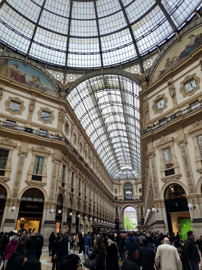 Lots of people inside a shopping arcade in Milan. Image by Velvet.