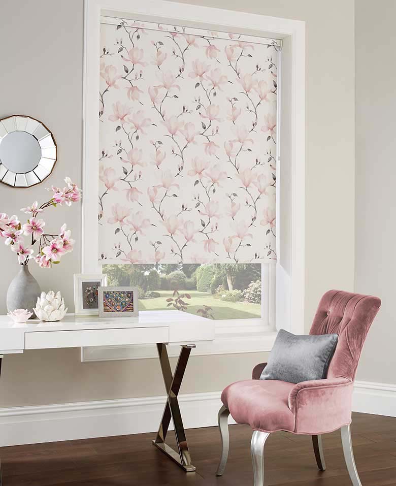 A stylish boudoir. The blind with a floral design compliments the velvet pink armchair beautifully. Image by Englishblinds.