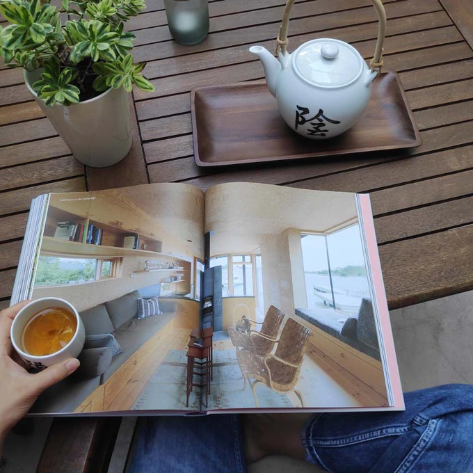 Embracing slow design and its principles. Tea drinking and magazine reading during slow living.