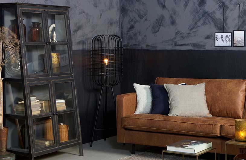 An industrial set with a tanned leather sofa that looks good when combined with this statement black metal hurricane floor lamp besides it. Image by Cuckooland.
