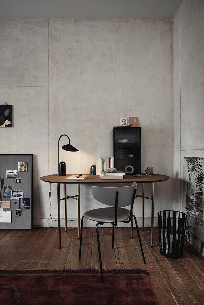 A industrial styled setting with a round dining table and a Ferm Living Herman chair. Image by Nest.