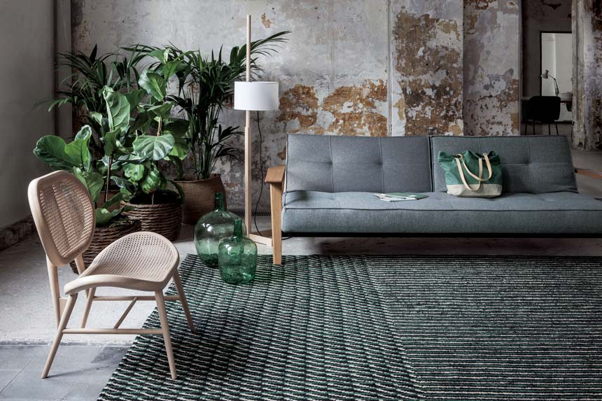 A green textured area rug in a living room with an organic vibe. Image via Nest.co.uk.