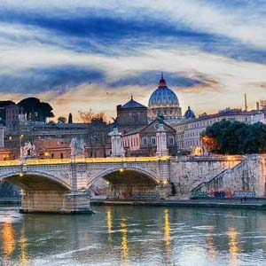 View of the Tiber river in Rome and St. Peters Cathedral in the background in Rome