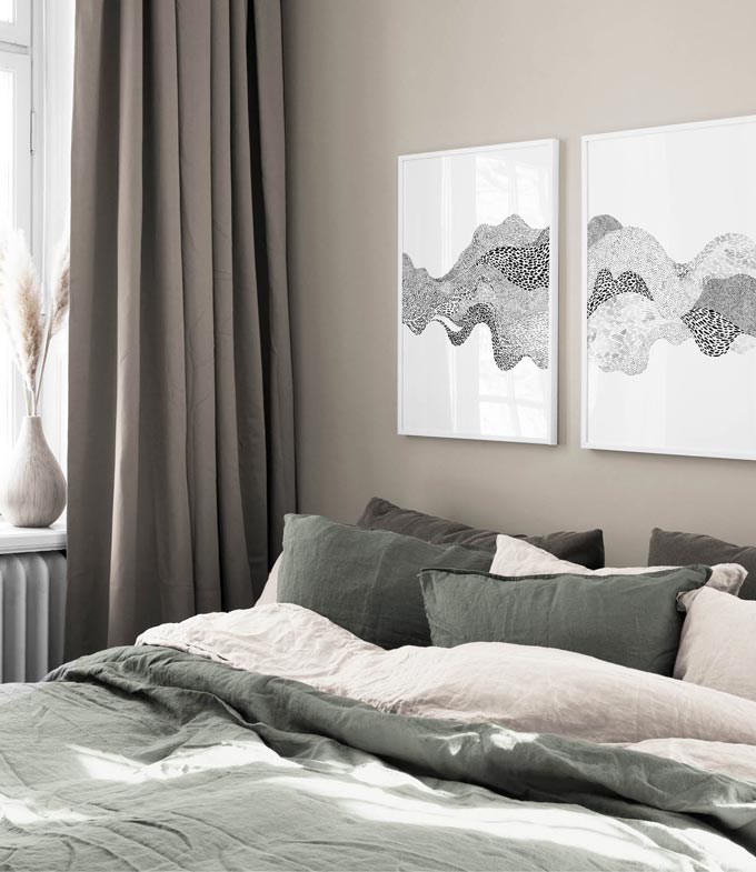 Two art prints in one grouping hanging over a muted grey contemporary bedroom. Image by Desenio.