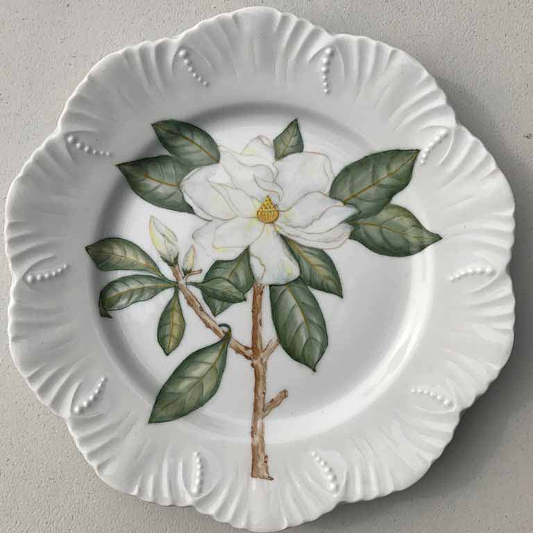 A white plate with a large white flower drawn on it