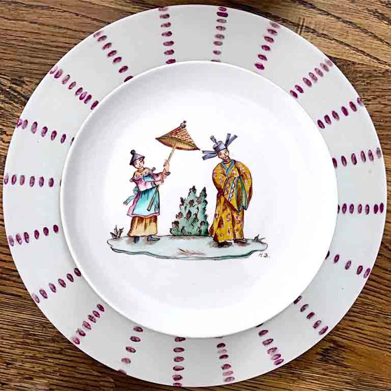 A hand painted porcelain dinner plate.