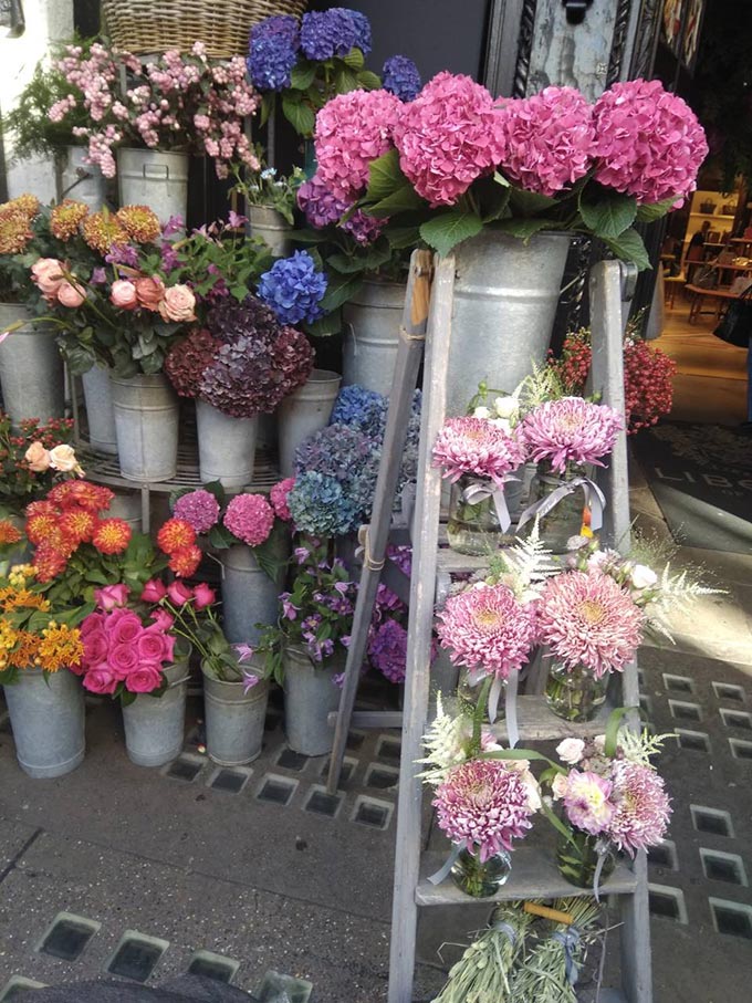 Flower bouquets for sale outside of flower shop in West End London.