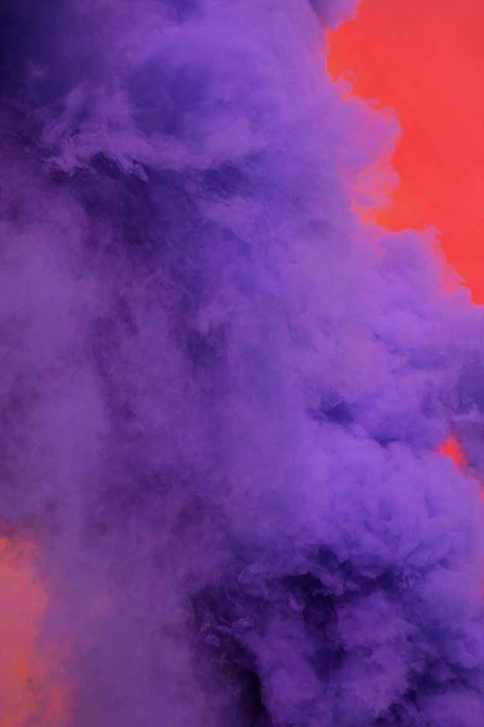 Purple smoke going up against a red background