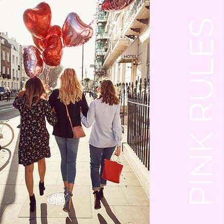 The girls-friends walking down the street with heart-shaped balloons celebrating Galentines. Image by Dorothy Perkins.