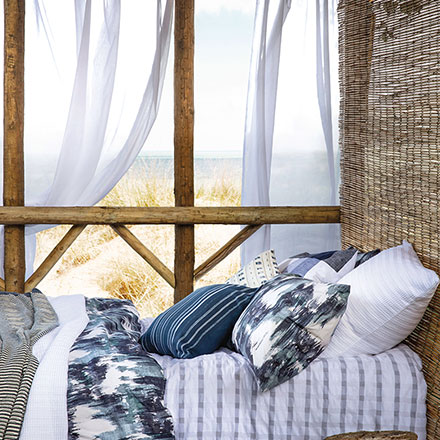 A beautiful literally breezy bed setup in a summer bungalow. Image by House of Fraser.