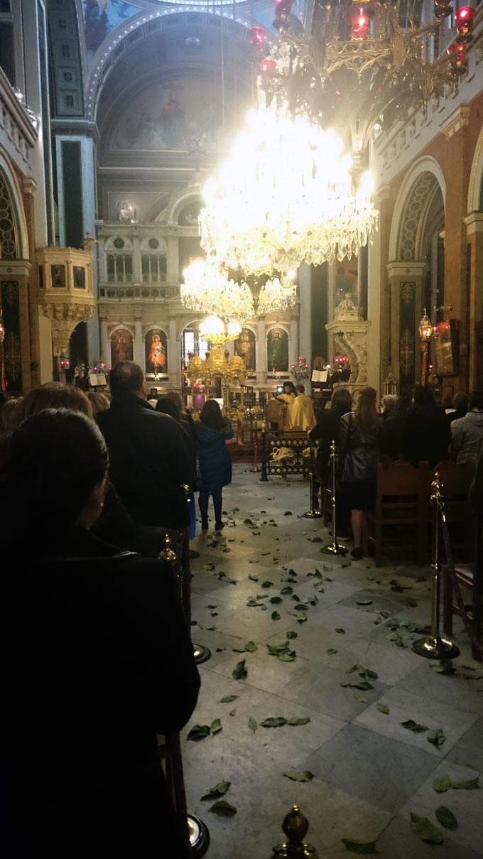 Inside a Greek Orthodox church on Holy Saturday morning. The leaves on the floor were scattered by the priests who announced just earlier that the Lord has risen.