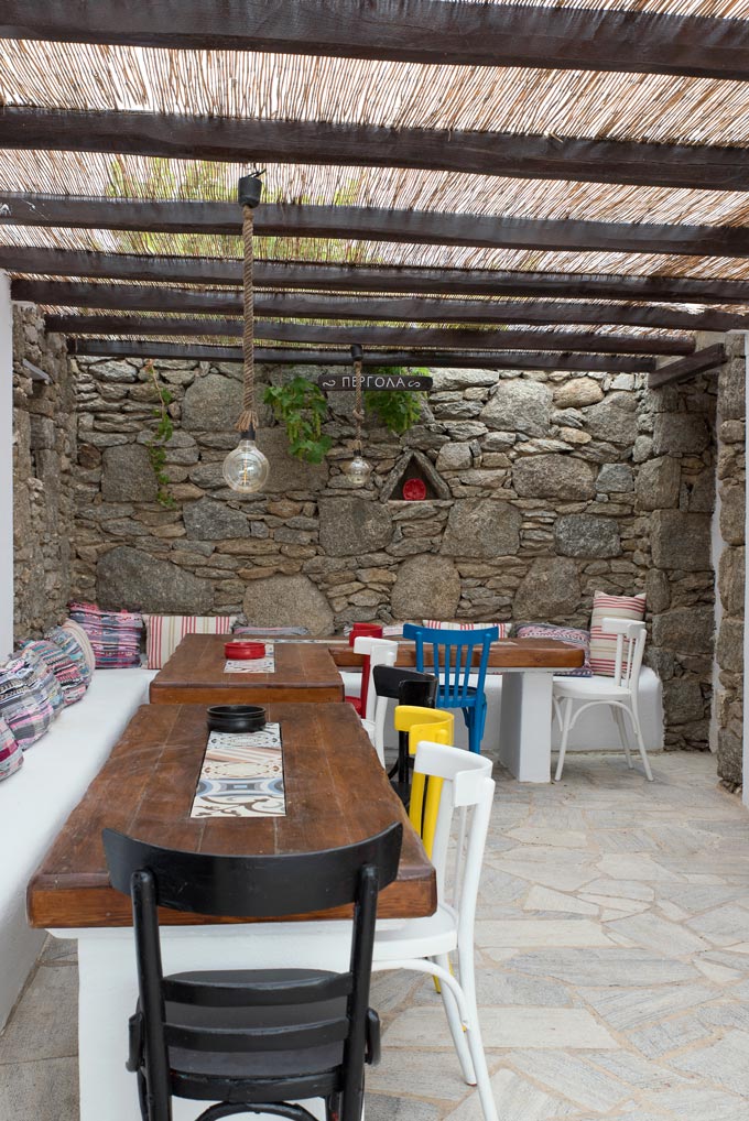 A Cycladic minimal outdoor space under a pergola at Bellou Suites in Mykonos. Image by Antonis Drakakis.