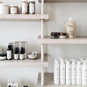 Shelves with cosmetic products lined up with a very organic flair to them.
