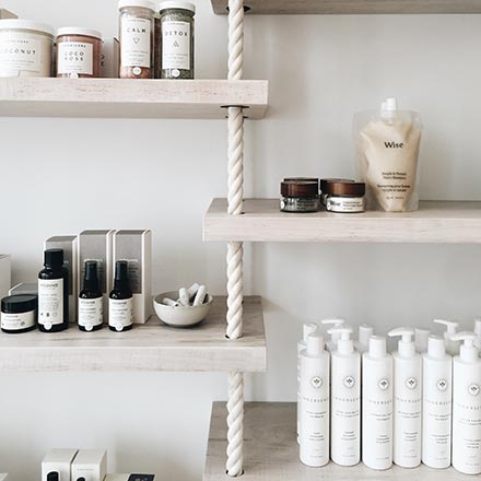 Shelves with cosmetic products lined up with a very organic flair to them.